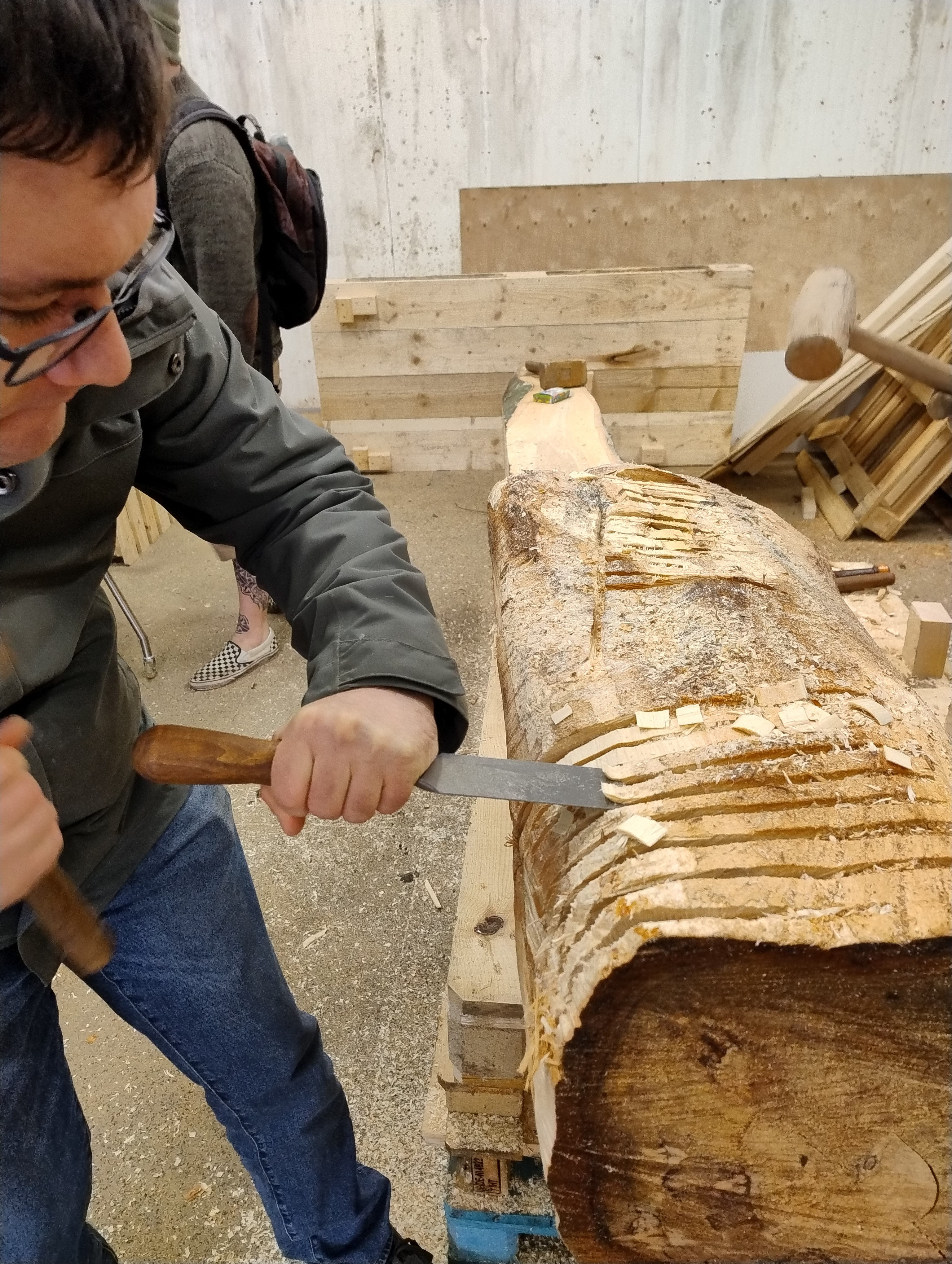 A person is shaping out the wood