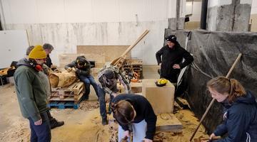 A group of of people doing different things in a workshop