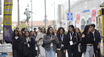 A group of young people walking confidently outside
