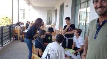 Students working in groups on a large balcony