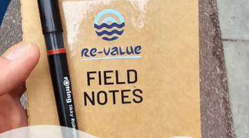 A picture of a Re-Value notebook and the name of the report