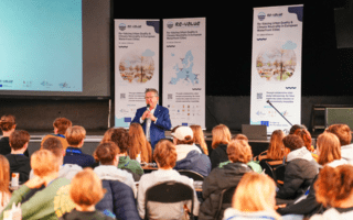 The Mayor of Bruges is speaking to a group of students