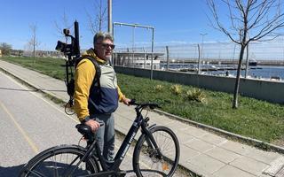 A man standing with an electric bike and a eoSLAM ZEB Horizon laser scanner A man standing with an electric bike and a eoSLAM ZEB Horizon laser scanner