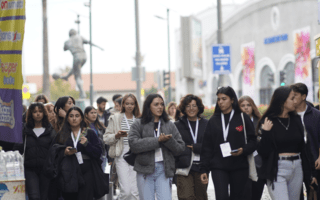 A group of young people walking confidently outside