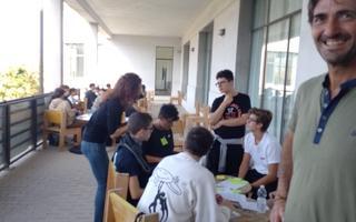 Students working in groups on a large balcony