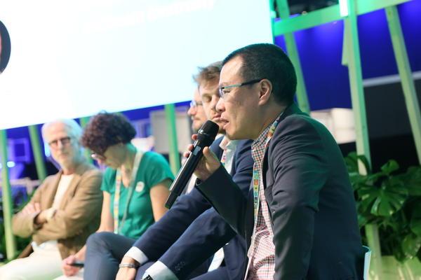 A group of people sitting on a stage