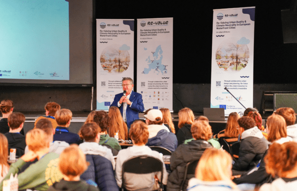 The Mayor of Bruges is speaking to a group of students