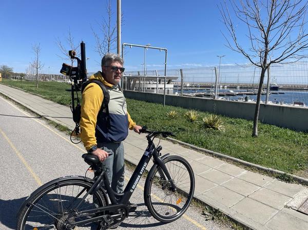 A man standing with an electric bike and a eoSLAM ZEB Horizon laser scanner A man standing with an electric bike and a eoSLAM ZEB Horizon laser scanner