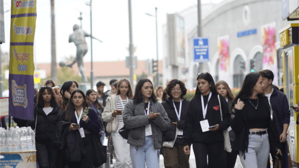 A group of young people walking confidently outside